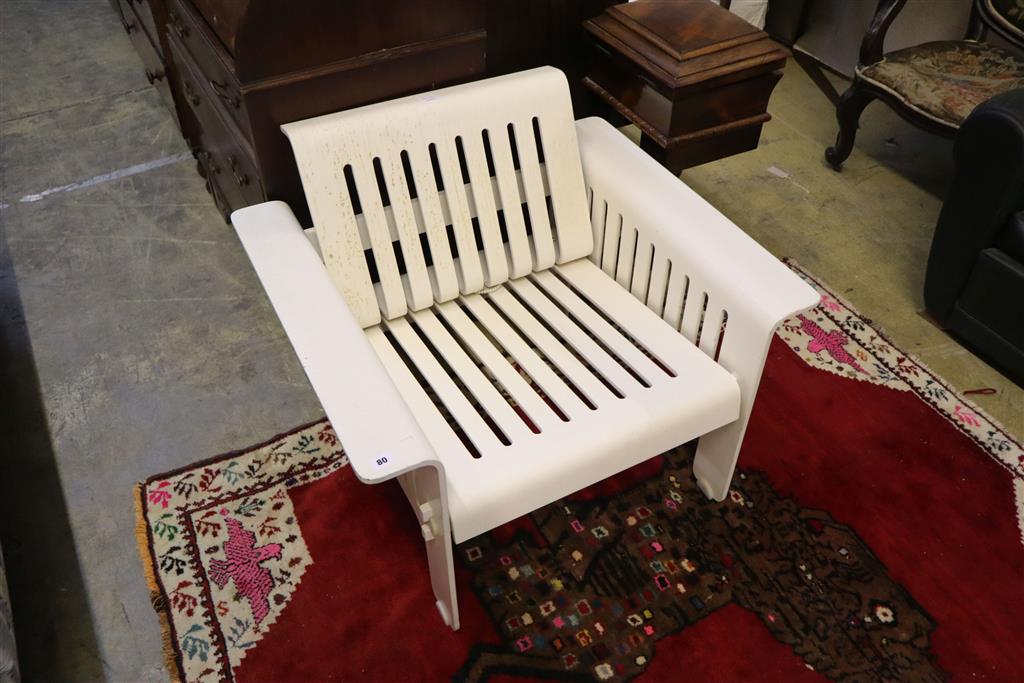 A 1960s white plastic armchair, with slatted slides